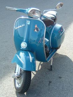 a blue scooter is parked on the street