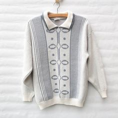 This is a lovely, knit sweater in white and grey knit design with double collar. Warm and cozy, perfect with your favourite jeans and comfy skirts.Made from 85% Acrylic and 15% Nylon.Size labeled: MediumMeasurements when laid flat are:Bust: 53cmWaistband: 39cmLength: 63cmSleeve Length: 49cmcAlthough the label is nearly washed out, the jumper itself is in an excellent condition. White Collared Knit Sweater, White Cable Knit Long Sleeve Polo Sweater, White Winter Polo Sweater With Ribbed Collar, White Ribbed Collar Polo Sweater For Winter, White Polo Sweater With Ribbed Collar For Winter, Classic White Jacquard Knit Sweater, Cozy White Polo Sweater For Winter, Cozy White Sweater With Ribbed Collar, Comfy Skirt