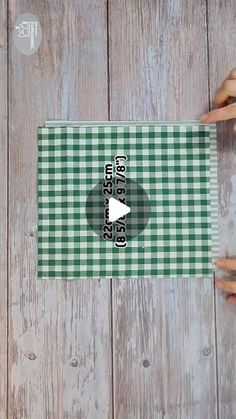 two hands holding onto a green and white checkered table cloth