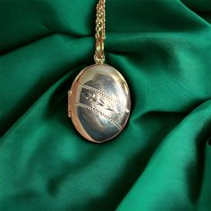 "Vintage engraved oval locket, on more modern 19.75\" inch gold plated chain. The locket is in 1.6\" inches long, including the bail. It is in good vintage condition, with signs of use.  Please contact me for combined shipping." Oval Metal Locket Necklace As Gift, Oval Locket Necklace With Adjustable Chain As Gift, Oval Etched Locket Necklace As Gift, Oval Pendant Locket Necklace With Adjustable Chain For Keepsake, Oval Metal Locket Necklace For Gifts, Metal Oval Pendant Locket Necklace, Oval Etched Locket Necklace For Gift, Silver Oval Locket Necklace With Adjustable Chain, Metal Oval Locket Necklace