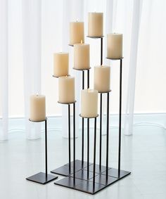 a group of candles sitting on top of a metal stand