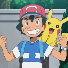 a young man in a baseball cap holding up a pikachu