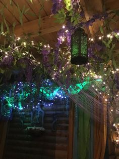 purple and green lights are hanging from the ceiling