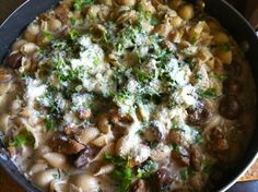 a pan filled with pasta and meat covered in cheese