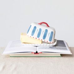 an open book with a cake on top of it