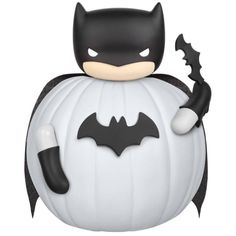 a batman figurine sitting on top of a white pumpkin