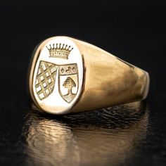 A regal engraving of two crests beneath a crown adorns the signet of this unique vintage ring. Substantial and prestigious, this ring feels both historic and fashion-forward. The thick band tapers in the back for an everyday comfortable fit. Metal: 18k Yellow GoldMeasurements: Width: 12-2mm Size 6.25 in stock Shipping and Delivery: IN STOCK items will ship within 2 business days Sizes not In Stock will be Resized Resize Fee may apply Please allow 2 weeks for delivery All Resize items are final s Gold Oval Signet Ring With Coat Of Arms, Classic White Gold Signet Ring For Ceremonial Occasions, Luxury Yellow Gold Signet Ring With Coat Of Arms, Classic Yellow Gold Engraved Ring With Coat Of Arms, Luxury Yellow Gold Coat Of Arms Signet Ring, Heirloom Oval Signet Ring With Coat Of Arms, Luxury Engraved Signet Ring For Formal Occasions, Luxury Hallmarked Signet Ring For Ceremonial Use, Classic Oval Signet Ring With Coat Of Arms