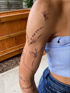 a woman with a flower tattoo on her arm