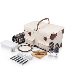 a picnic bag with utensils, wine glasses and other items laid out on the table