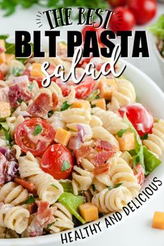 the best blt pasta salad is in a bowl with tomatoes and lettuce