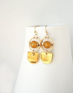 ★★★Golden yellow orbs of agate glow within these earrings. Need an earring that works well with work outfits and brunch dates, this piece is for you. + Yellow Agate. 14K Gold Fill Ear Wire. 14K Gold Plate Findings.+ Length: 1.5 inches.+ Earring take 1 day to make.+ Your jewelry will come in a jewelry box, tied with a ribbon.➤➤ Have a question about this product, reach out to me here ➙ https://www.etsy.com/conversations/new?with_id=9057464&referring_id=5772224&referring_type=shop&recipient_id=905 Handmade Yellow Brass Earrings, Yellow Brass Dangle Jewelry, Modern Yellow Earrings For Everyday Wear, Modern Yellow Earrings For Everyday, Elegant Yellow Earrings With Natural Stones, Yellow Brass Earrings As A Gift, Yellow Brass Jewelry With Matching Earrings, Modern Yellow Dangle Earrings, Gold Earrings With Natural Stones For Everyday