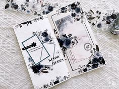 an open notebook with black and white flowers on it