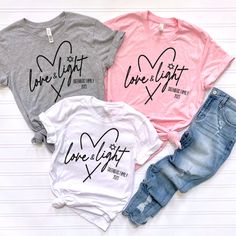 three t - shirts with the words love light and one that has hearts on it