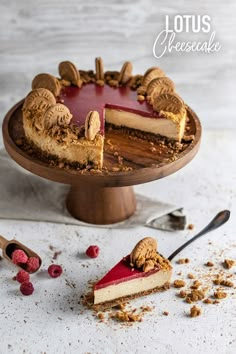 a cheesecake with raspberry filling on a wooden cake stand