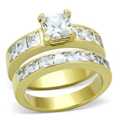 two gold wedding rings with princess cut diamonds on each band and channeled diamond set in the middle