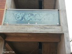 a glass window on the side of a building that has been painted with blue and white designs