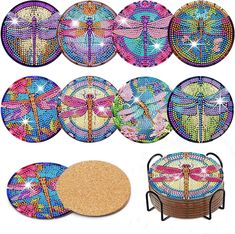 six coasters with dragonflies on them, one is pink and the other is blue