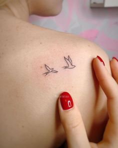 a woman's arm with two birds on it and the word love written in cursive writing