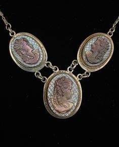 Beautiful, antique c. 1901-1910, three cameo pendant necklace.  If you love the romantic gothic style jewelry, this piece is for you.  The necklace features three carved faces of Victorian ladies on mother-of-pearl abalone shell.  There is a small gold rope detail wrapped around the cameo.  Unsure if it could be gold or brass due to its sheen.  One cameo is missing it.   Antique condition with some light tarnishing, I have not attempted to clean or polish.  I do not have information on the origin of this necklace, I acquired it at an estate.  The chain and setting are made of .800 Silver, 80% 20% other metal alloys.  There is a marking on the spring ring clasp that I can't make out.  It was common for jewelry from this period to be made from .800 silver.  The chain measures 17" long.  Came Formal Art Nouveau Necklace, Ornate Cameo Jewelry For Anniversary, Victorian Cabochon Pendant Necklace, Victorian Pendant Necklace With Cabochon, Victorian Cameo Jewelry For Anniversary, Victorian Jewelry With Cabochon Medallion, Art Nouveau Oval Cameo Jewelry, Victorian Cameo Jewelry As Gift, Victorian Cabochon Collectible Jewelry