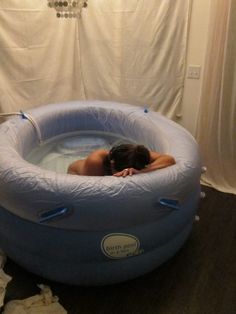 a woman laying in an inflatable swimming pool