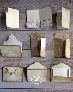 many different pieces of wood are arranged on the wall, including envelopes and mailboxes