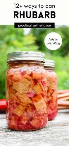 two jars filled with pickled fruit sitting on top of a table next to vegetables