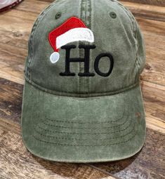 Fun Holiday, Christmas hat with Ho and Santa Hat. Available in green and black, Please specify when ordering. Green Snapback Baseball Cap For Winter, Adjustable Christmas Cap, Winter Green Baseball Cap, Casual Christmas Cap, Casual Christmas Hat, One Size Fits Most, Casual Christmas Hat One Size Fits Most, Casual Christmas Hat, Baseball Santa, Christmas Baseball