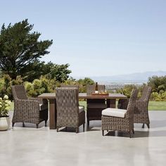 an outdoor dining table and chairs set up on a patio