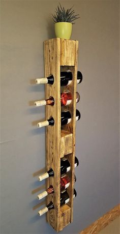 a wooden wine rack with several bottles in it