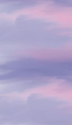 an airplane flying in the sky with pink clouds