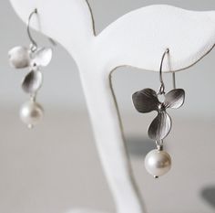 Glam Orchid Earrings. Silver. Swarovski Pearl. Bridal Attire Silver Pearl Drop Flower-shaped Earrings, Silver Flower Earrings With Pearl Drop, Silver Sterling Pearl Drop Flower Earrings, Silver Sterling Flower Earrings With Pearl Drop, Hypoallergenic Sterling Silver Flower Earrings For Wedding, Formal Silver Earrings With Flower Charm, Minimalist Sterling Silver Flower Earrings For Wedding, Elegant Hypoallergenic Silver Flower Earrings, Elegant Nickel-free White Gold Flower Earrings