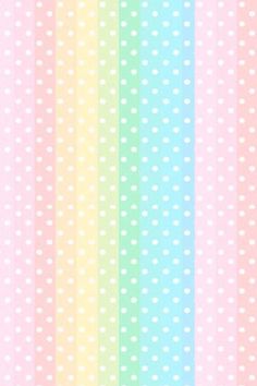 a rainbow colored wallpaper with white polka dots