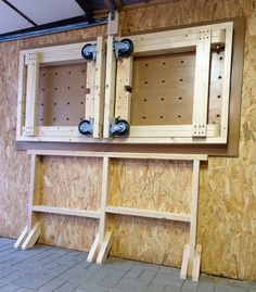 the inside of a building that is being built with plywood boards and wooden shelves