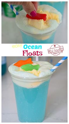 two cups filled with blue liquid and topped with whipped cream, candy flakes and an orange slice