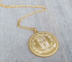 "We have just found your new 'go-to' everyday necklace with our large gold coin necklace. This necklace is so versatile, meaning you can wear it on its own during the day, layered with other pieces for a fun night out, or paired with other gold pieces for an evening-ready look. This necklace has an intricately-designed 14 karat gold plated coin-inspired charm hanging delicately from a 14k gold filled chain necklace. Coin pendant is a two-sided pendant. The oversized coin design is big enough to Gold Medallion Locket Necklace, Gold Medallion Necklace With Large Pendant, Gold Coin Necklace With Large Pendant, Gold Coin Pendant Medallion Necklace, Gold Medallion Necklace With Coin Pendant, Coin Necklace Gold, Necklace Long Gold, Long Necklace Gold, Necklace Gold Pendant