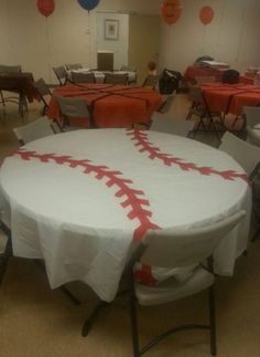 a baseball themed table cloth is set up in the middle of a room with balloons