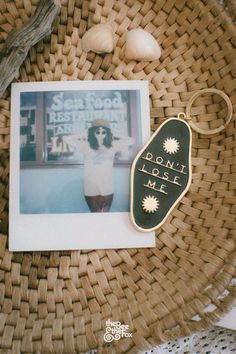 a photo and keychain sitting on top of a basket next to an egg