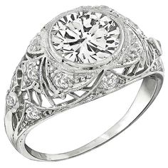 an art deco style diamond ring with filigrees