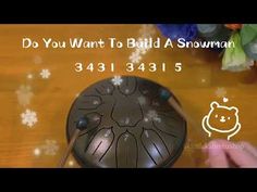 a person is using a snow blower on a wooden table with the words do you want to build a snowman?