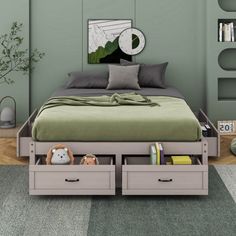 a bed with two drawers underneath it in a room that has green walls and carpet