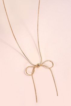 Introducing our Snake Chain Bow Pendant Necklace, a perfect blend of elegance and contemporary style. This exquisite necklace features a finely crafted bow pendant that adds a touch of femininity and charm. The smooth snake chain provides a sleek and modern backdrop, enhancing the pendant's delicate design. Ideal for both everyday wear and special occasions, this versatile necklace effortlessly elevates any outfit. Product Details:length: 16"charm: 2.75"ext: 3" Ball Chain Extclasp: Lobster Clawm Gold Necklace With Decorative Bow For Party, Elegant Gold Necklace With Decorative Bow, Elegant Gold Necklace With Bow Detail, Elegant Gold Necklace With Bow, Formal Gold Necklaces With Ribbon, Formal Gold Necklace With Ribbon, Formal Gold Ribbon Necklace, Adjustable Necklace With Decorative Bow, Elegant Bow Pendant Necklace