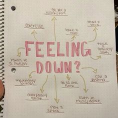 a notepad with writing on it that says feeling down and arrows pointing in different directions