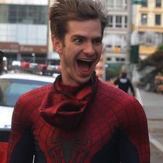 a man in a spider - man costume is making a funny face