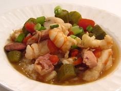 a white plate topped with shrimp and vegetables