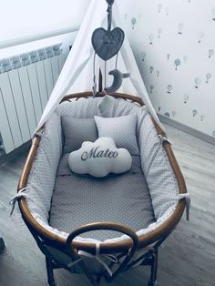 a baby crib with a pillow on top of it