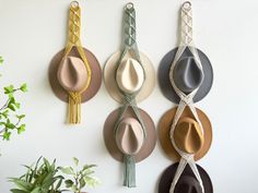 four hats are hanging on the wall