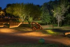 an illuminated sculpture in the middle of a park at night