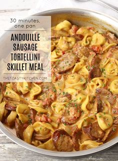 a skillet filled with sausage and tortelli shells, topped with parsley