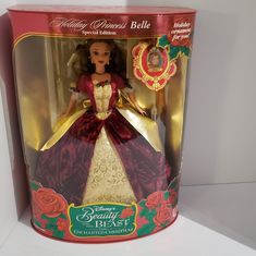 the doll in the box is wearing a red dress