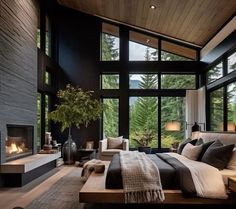 a bedroom with a large bed and lots of windows on the wall, along with a fireplace